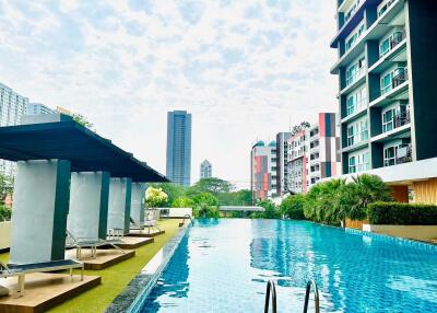 Modern apartment complex with pool and lounge area