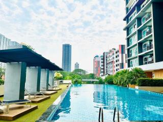 Modern apartment complex with pool and lounge area