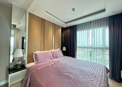 Spacious bedroom with a large bed, expansive windows, and modern design