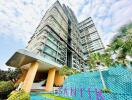 Modern high-rise residential building with distinctive entrance