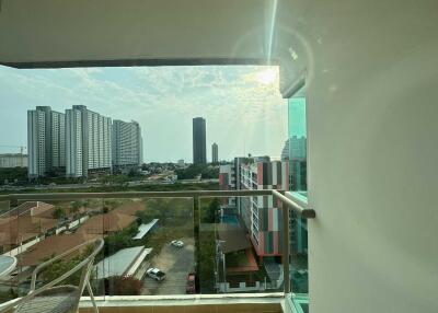 Balcony view of a high-rise residential area with cityscape and clear skies