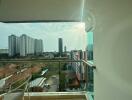 Balcony view of a high-rise residential area with cityscape and clear skies