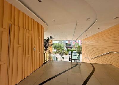 Modern building lobby with natural lighting and wooden panel walls