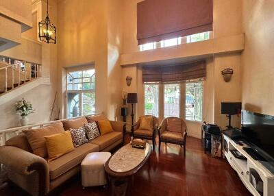 Spacious living room with high ceilings and ample natural light