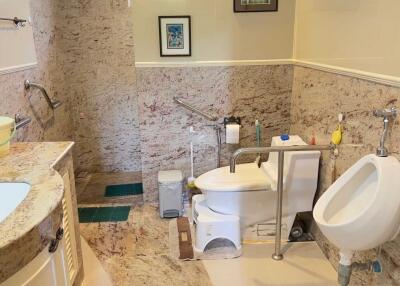 Modern bathroom with granite walls and tiled floor