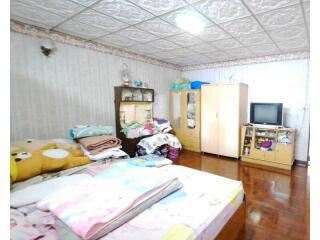 Spacious bedroom with wooden flooring and multiple pieces of furniture