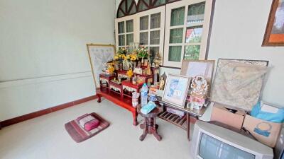 Spacious living room with traditional decorations and an altar