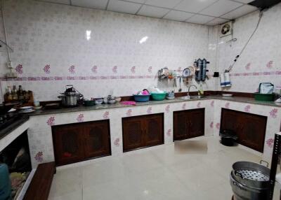 Spacious kitchen with tiled walls and ample counter space