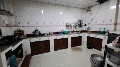 Spacious kitchen with tiled walls and ample counter space