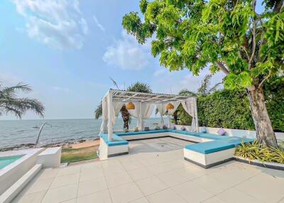 Luxurious seaside outdoor area with lounge and canopy