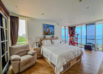 Spacious bedroom with ocean view and balcony access