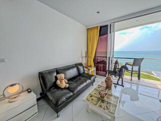 Bright living room with ocean view and balcony access