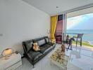 Bright living room with ocean view and balcony access