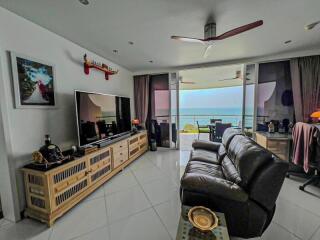 Spacious living room with a seaside view, modern furniture and ample lighting
