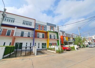 Colorful townhouses with clear skies and parking space