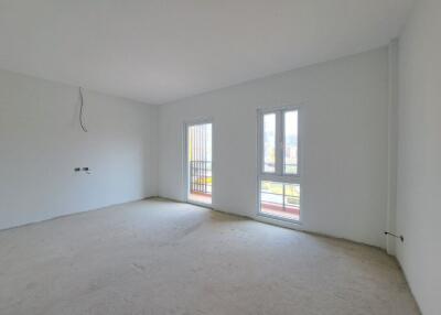 Spacious unfurnished living room with large windows and natural light