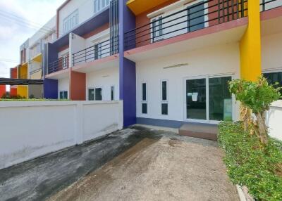 Colorful townhouse exterior with parking space