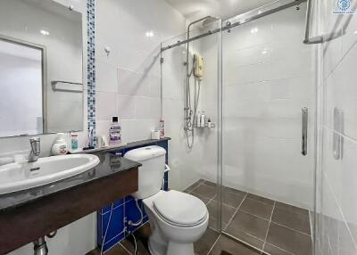 Modern clean bathroom with shower and white tiling