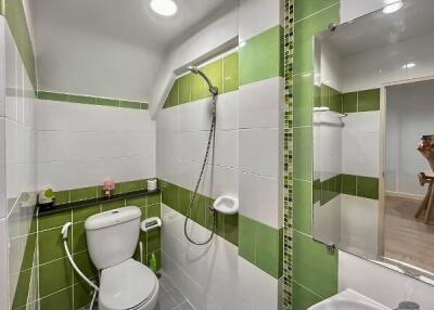 Modern bathroom interior with green and white tiles