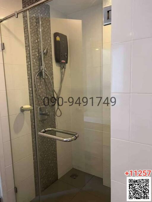 Modern tiled bathroom with wall-mounted electric shower