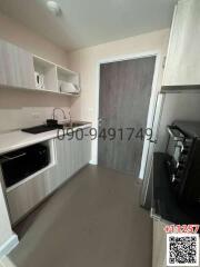 Compact modern kitchen with appliances and grey cabinetry