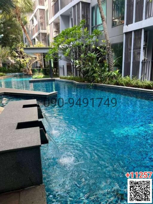 Tranquil outdoor swimming pool surrounded by modern residential buildings