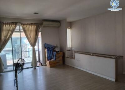 Spacious living room with natural light and air conditioning unit
