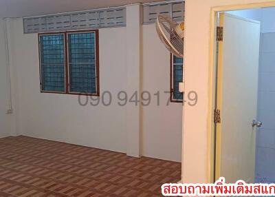 Spacious unfurnished bedroom with tiled flooring and large windows