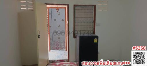 Interior view of a room with doors and a refrigerator