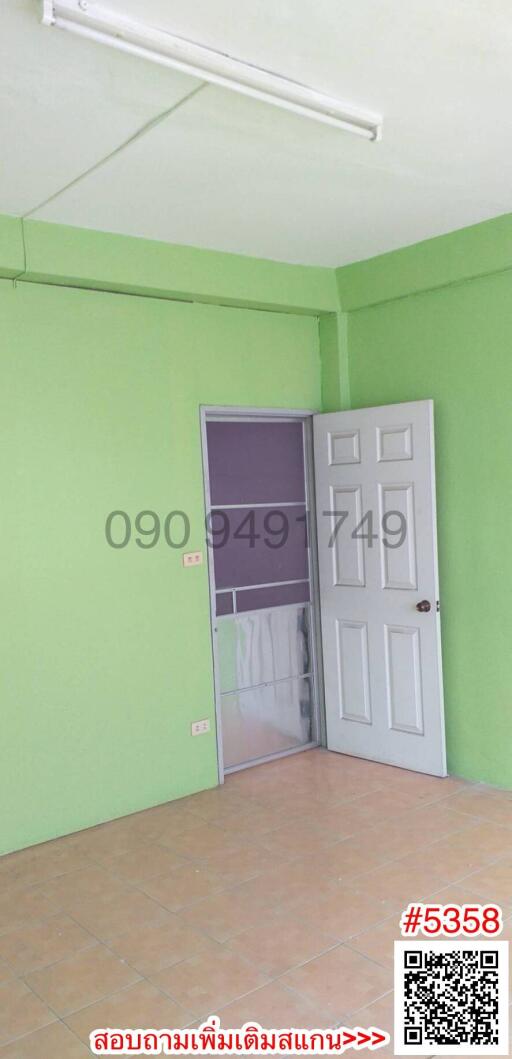 Empty bedroom with green walls and white door