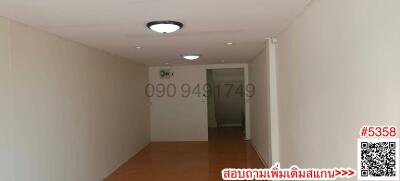 Empty hallway interior with light fixtures and terracotta tiled floor
