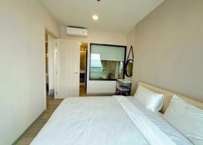 Spacious bedroom with modern design, ample lighting, and air conditioning