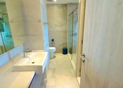 Modern bathroom interior with a large mirror and glass shower