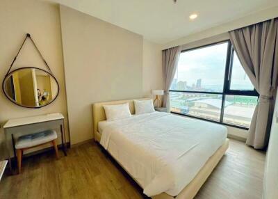 Well-lit bedroom with a view of the city