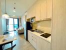 Modern kitchen with adjacent living room in an apartment