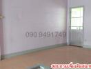 Empty interior space with tiled flooring and a door leading outside