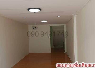 Spacious hallway in a residential building with tiled flooring and neutral wall colors