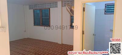 Empty bedroom with tiled flooring and natural light