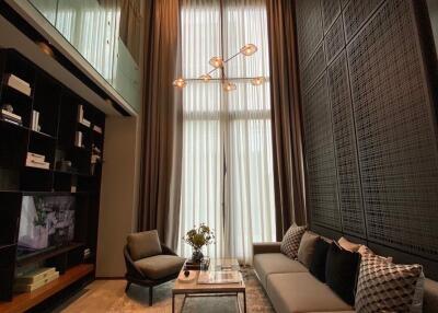 Stylish modern living room with tall curtains and designer lighting