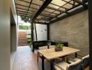 Spacious covered patio with dining area and garden view
