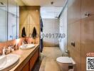 Modern bathroom with dual sinks and beige tiles