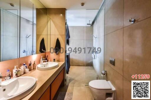 Modern bathroom with dual sinks and beige tiles