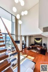 Spacious and modern living room with city view, staircase and beautiful lighting