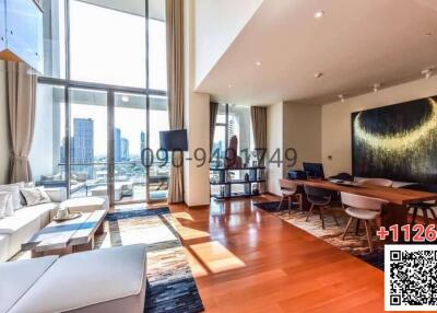 Spacious living room with large windows, modern furniture, and city view