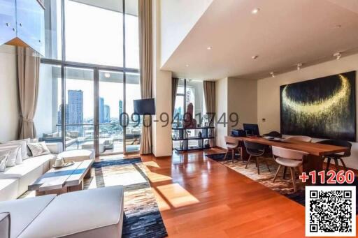 Spacious living room with large windows, modern furniture, and city view