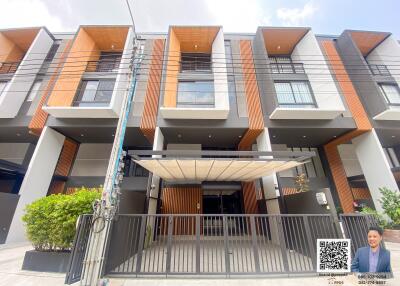 Modern townhouse exterior with brick facade and covered entrance