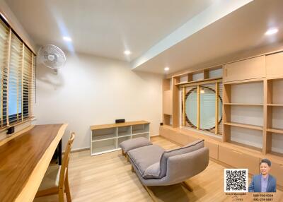 Spacious modern living room with comfortable seating and shelving units