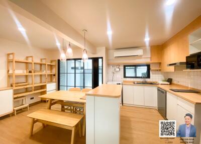 Modern kitchen with wooden dining table and open shelving