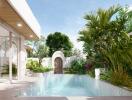 Elegant outdoor swimming pool with adjacent patio and lush garden