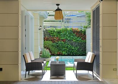 Cozy patio area with comfortable seating and a vertical garden